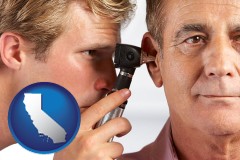 california an audiologist examining the ear of a patient
