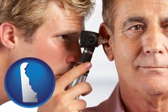delaware an audiologist examining the ear of a patient