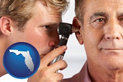 florida an audiologist examining the ear of a patient