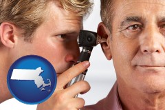 massachusetts an audiologist examining the ear of a patient