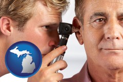 michigan an audiologist examining the ear of a patient