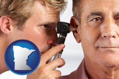 minnesota an audiologist examining the ear of a patient