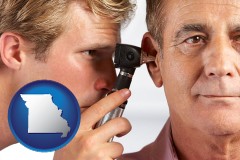 missouri an audiologist examining the ear of a patient