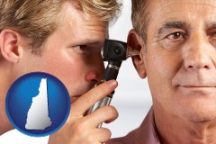 new-hampshire an audiologist examining the ear of a patient
