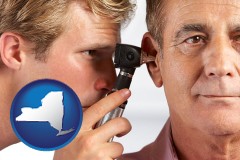 new-york an audiologist examining the ear of a patient