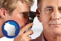 wisconsin an audiologist examining the ear of a patient