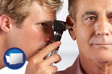 an audiologist examining the ear of a patient - with Washington icon